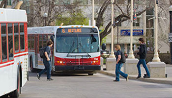 Transit bus with people walking around it