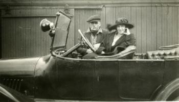 Red Deer Archives, P435; Arch Mitchell and wife in an open top car, 192?