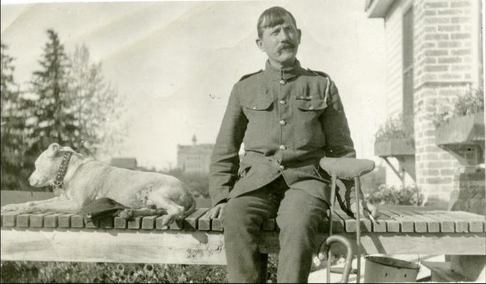 Red Deer Archives, P5422; A convalescing veteran and his dog on a porch of a house in Red Deer, 1918