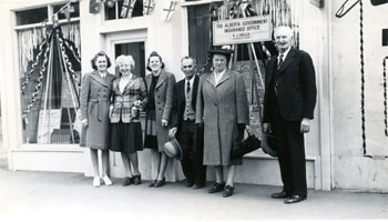 Photo of people posing in front of Rollis Block building circa 1953