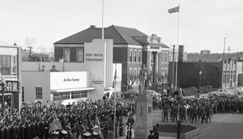 A crowd of people gathered around the Cenotaph for a Memorial Day service.