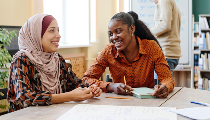 Newcomers enjoy a conversation in a public facility