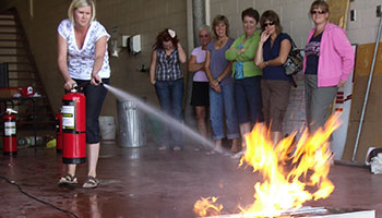 Fire Extinguisher Trainee putting out a fire