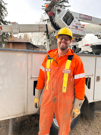 Staff member standing in front of a truck