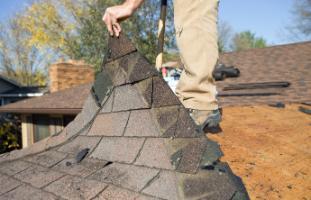 Shingles being torn off a roof (JPG)