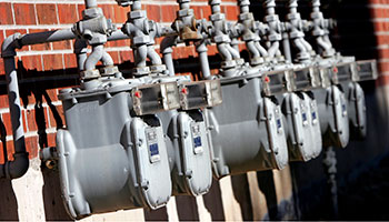 image of gas lines going in to a brick building