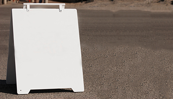 sandwich board sign on road