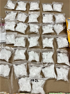 Table with mulitple packets of Methamphetamine seized on March 25 and 26