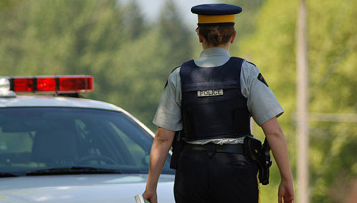 Female police officer walking back towards police car