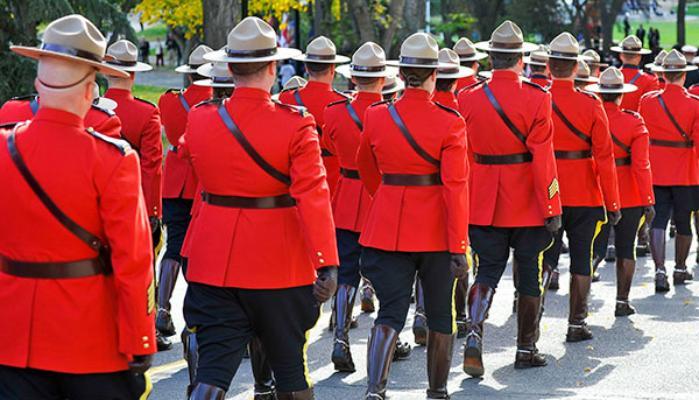 RCMP members marching wearing red serge