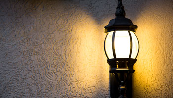 photo of outside wall light illuminating the darkness