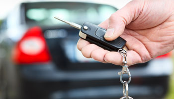 Photo of person locking vehicle with the key fob