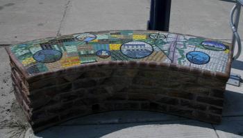 Curved bench made from brick designed with glass mosiac tiles.