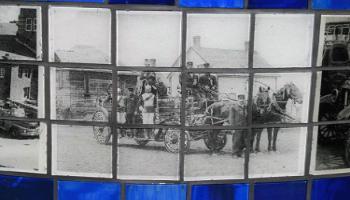 Close up of an old photograph etched into a glass tile on a rectangle sculpture.