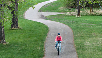 photo of a cyclist on a bike trail