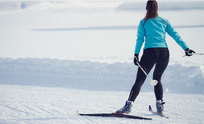 Cross country skiier gliding over the snow