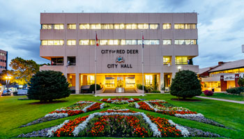 photo of flower beds in City Hall Park with City Hall in the background