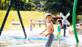 photo of boy playing in Spray Park at Rotary Recreation Park