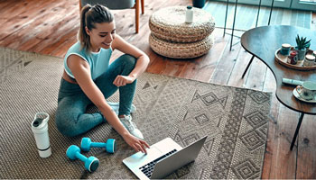 Woman using laptop preparing to exercise